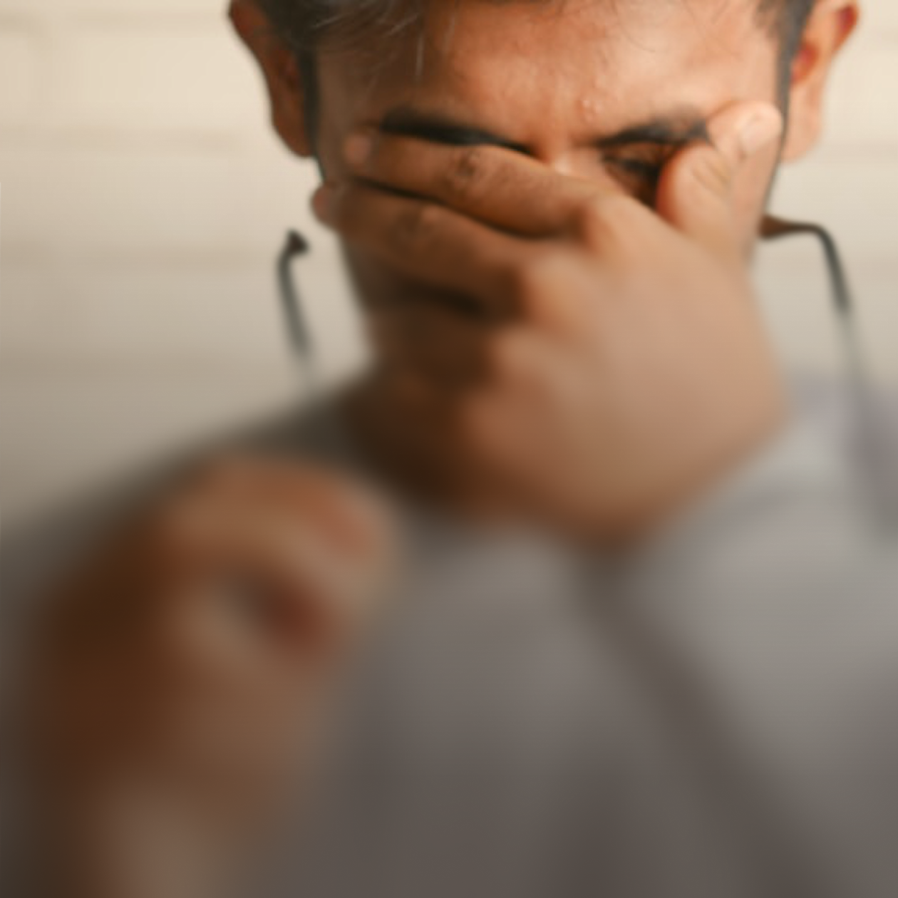Man rubbing eyes, mentally fatigued